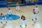 Girls cheerleading appear on basketball parquet