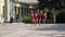 Girls from cheerleading team in pink tunics are dancing on playground