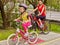 Girls children cycling on yellow bike lane.