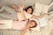 Girls children lay on bed with cute pillows top view. Pajamas party concept. Girls have fun. Girlish secrets honest and