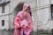 Girls children walking in the rain dressed in a raincoat