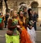 Girls costumed in colorful costume of fairy tales walking down the street during the carnival