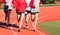 Girls cross country team running on a track