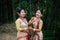 Girls in dance move isolated dressed in traditional wearing on festival with blurred background