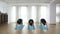 Girls doing synchronized yoga sequence at a gym