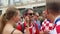 Girls draw flags on soccer fan face