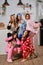 Girls dressed up in plush pajamas in form of cartoons characters are having fun at bachelorette party, posing against a