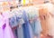 Girls` dresses are hung on shelves in children`s clothing stores. Lovely dresses for girls on birthdays, holiday, competitions,..