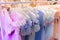 Girls` dresses are hung on shelves in children`s clothing stores. Lovely dresses for girls on birthdays, holiday, competitions,..