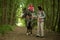 Girls enjoying horseback riding in the woods with mother, young pretty girls with blond curly hair on a horse, freedom