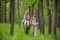 Girls enjoying horseback riding in the woods with mother, young pretty girls with blond curly hair on a horse, freedom