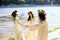 Girls in ethnic clothes with wreath of flowers celebrating