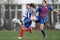 Girls fighting for ball during soccer game