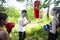 Girls fighting boxing outside with coach in green park, sport summer people concept