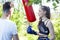 Girls fighting boxing outside with coach in green park, sport summer people concept