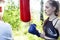 Girls fighting boxing outside with coach in green park, sport summer people concept