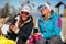 Girls friends enjoying hot drink in cafe at ski resort. Sunbathing in snow