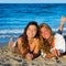 Girls friends having fun happy lying on the beach