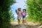 Girls with gardening tools. Agriculture concept. Adorable girls in hats going planting plants. Sisters helping at farm