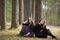 Girls girlfriends sitting together in a pine forest. Nature.