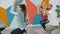 Girls and guy practising eagle position during yoga class in modern sports center