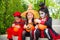 Girls in Halloween costume sitting on stair and smile