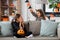 Girls in halloween costumes playing with spider