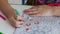 Girls hands draw with crayons in antistress coloring