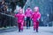 Girls are having fun in water on street in cold autumn day, girls splashing water in rain