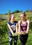 Girls holding white grapes in hands at vineyard summer