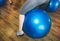 Girls are jumping on blue fitballs in the fitness centre. Exercise balls in the gym for healthy lifestyle living. Woman in black