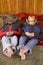 Girls laying with hats over heads feet on hay