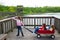 Girls looking at park lake with outdoor dump cart