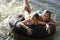 Girls Lying On Float Tube At Lake