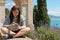 Girls make play with cellular phone in the riviera coast, liguria, italy