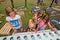 Girls making music & playing piano on a green playground