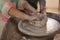 Girls making pot in pottery workshop