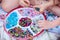 Girls making snowflakes and flowers with the box of various beads and pipe cleaners