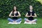 Girls meditation stretching outside park