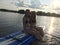 Girls paddle boarding on lake.