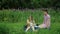 Girls play with dolls on grass