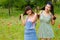 Girls play their hair in poppy flower field