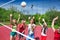 Girls play together volleyball on the playground