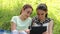 Girls playing on digital tablet outdoors