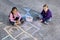 Girls playing with sidewalk chalk