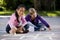 Girls playing with sidewalk chalk