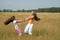 Girls plays on a meadow