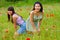 Girls pose picture in poppy flower field