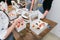 Girls prepare beautiful and tasty desserts on a wooden table and decorate with fruits