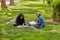Girls are preparing for classes on lawn in park, Iran.